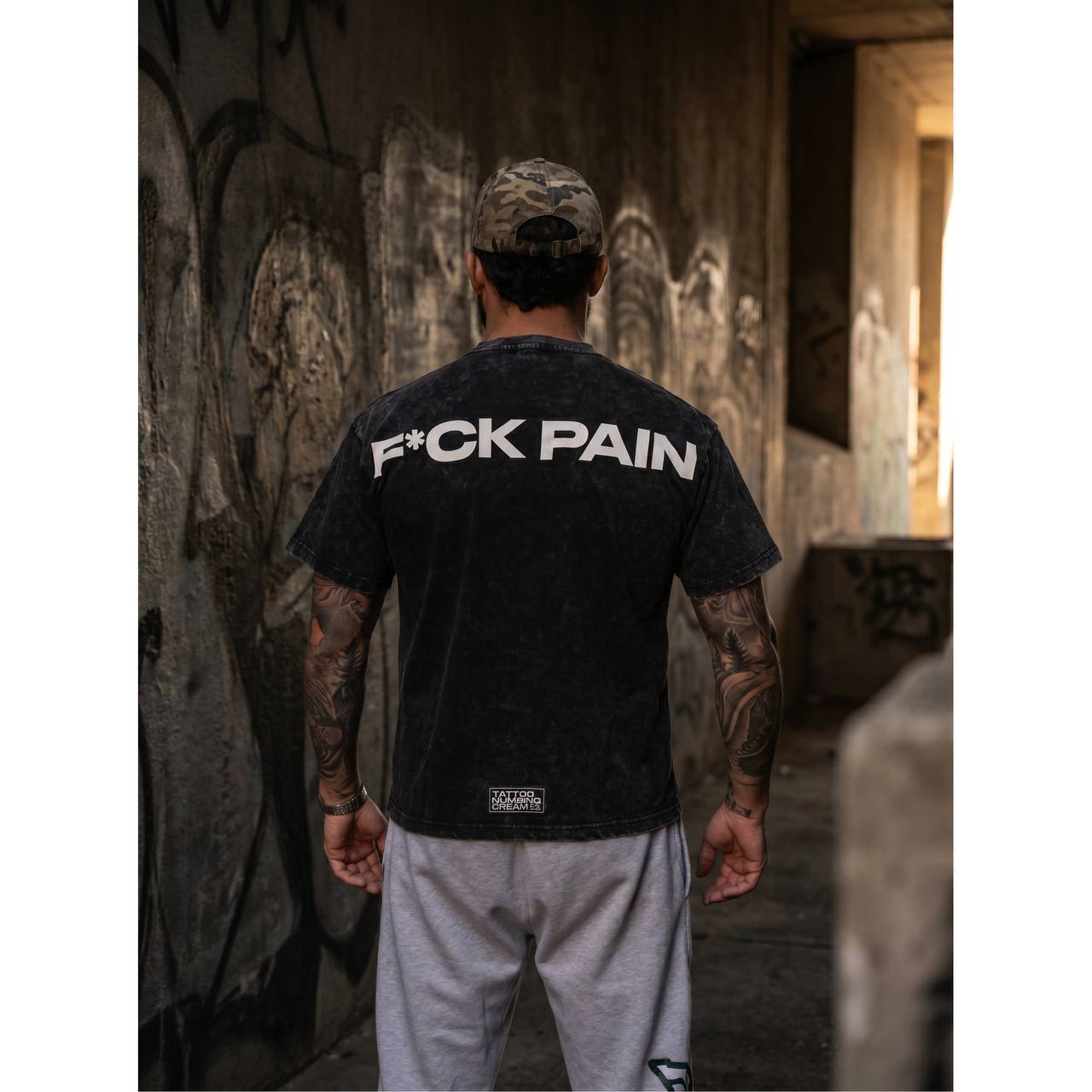 F*CK PAIN Merch Bundle — lifestyle back graffiti wall